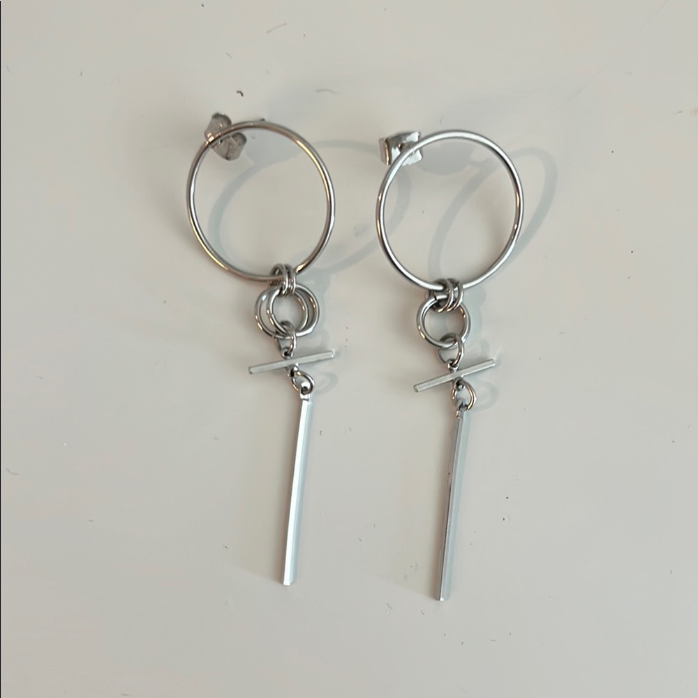Silver earrings with cross charm.